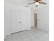 This bedroom features ample closet space, tile flooring, and neutral paint at 928 Avenal Ln, Davenport, FL 33837