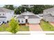 Charming single-story home with brick driveway, attached garage, and well-manicured front lawn at 928 Avenal Ln, Davenport, FL 33837
