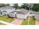 Well-maintained single-story home with neutral siding, an attached garage and a brick paver driveway at 928 Avenal Ln, Davenport, FL 33837