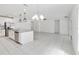 Spacious kitchen includes stainless steel appliances, granite countertops, and opens to a large, tiled living area at 928 Avenal Ln, Davenport, FL 33837