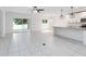 Open-concept kitchen with a large island, stainless steel appliances, and sliding glass door to backyard at 928 Avenal Ln, Davenport, FL 33837