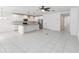 Open-concept kitchen with a large island, stainless steel appliances, and plenty of white cabinetry at 928 Avenal Ln, Davenport, FL 33837