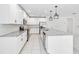 Bright kitchen features white cabinets, stainless appliances, granite countertops, and stylish pendant lighting at 928 Avenal Ln, Davenport, FL 33837