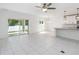 Open-concept kitchen with a large island, stainless steel appliances, and sliding glass door to backyard at 928 Avenal Ln, Davenport, FL 33837