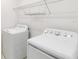 Bright laundry room with washer, dryer, and storage shelf at 928 Avenal Ln, Davenport, FL 33837