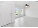 Bright, airy living room features neutral walls, tile flooring, and ample natural light from the surrounding windows at 928 Avenal Ln, Davenport, FL 33837