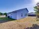 A view of the backyard highlighting a light-blue home exterior at 929 Monroe Harbor Pl, Sanford, FL 32773