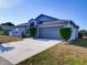 Charming single-story home with a well-maintained lawn and inviting two-car garage at 929 Monroe Harbor Pl, Sanford, FL 32773