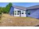 Rear exterior view of home highlighting sunroom and backyard at 929 Monroe Harbor Pl, Sanford, FL 32773