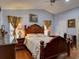 Elegant main bedroom featuring hardwood floors, a decorative headboard, and warm lighting at 929 Monroe Harbor Pl, Sanford, FL 32773
