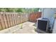 Outdoor patio with a fenced backyard and AC unit at 980 Canal View Blvd # N2, Port Orange, FL 32129