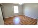 Neutral bedroom featuring wood floors, ceiling fan, and a window at 980 Canal View Blvd # N2, Port Orange, FL 32129