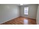 Simple bedroom featuring wood floors, a ceiling light, and a window at 980 Canal View Blvd # N2, Port Orange, FL 32129