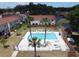 Community pool with palm trees and lounge chairs at 980 Canal View Blvd # N2, Port Orange, FL 32129