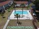 Aerial view of a community pool with palm trees and lounge chairs at 980 Canal View Blvd # N2, Port Orange, FL 32129