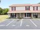 Cozy two-story condo with red shutters, covered porch, and parking spots marked for guest and residents at 980 Canal View Blvd # N2, Port Orange, FL 32129