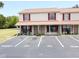 Comfortable two-story condo with red shutters and covered porch near reserved and guest parking spots at 980 Canal View Blvd # N2, Port Orange, FL 32129