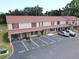 Two-story condo building featuring red shutters, covered front porches, and ample parking at 980 Canal View Blvd # N2, Port Orange, FL 32129