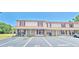 Charming two-story condo building featuring red shutters and covered front porches in a sunny setting at 980 Canal View Blvd # N2, Port Orange, FL 32129