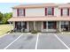 Attractive two-story condo featuring red shutters, a covered porch, and convenient parking at 980 Canal View Blvd # N2, Port Orange, FL 32129
