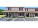 Inviting two-story condo featuring red shutters, covered porch, and convenient parking at 980 Canal View Blvd # N2, Port Orange, FL 32129