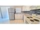 Well-lit kitchen featuring white cabinets, neutral countertops, and stainless steel appliances at 980 Canal View Blvd # N2, Port Orange, FL 32129