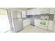 Updated kitchen with stainless steel appliances, white cabinets, and modern backsplash at 980 Canal View Blvd # N2, Port Orange, FL 32129