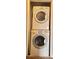 Stacked washer and dryer appliance inside the home at 980 Canal View Blvd # N2, Port Orange, FL 32129