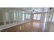 Open living room with tiled floors, mirror accents, and lots of natural light from the windows at 980 Canal View Blvd # N2, Port Orange, FL 32129