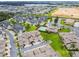 Wide aerial shot of a community featuring homes, lush landscaping, a pool, and well-maintained streets at 13241 Fountainbleau Dr, Clermont, FL 34711