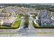 Expansive aerial view of a community showcasing multiple townhomes surrounding a central pool and clubhouse area at 13241 Fountainbleau Dr, Clermont, FL 34711