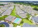 An aerial view of a community highlighting a pool and clubhouse, townhomes, and landscaping at 13241 Fountainbleau Dr, Clermont, FL 34711
