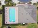 An aerial view of a private pool within a gated community and green landscaping at 13241 Fountainbleau Dr, Clermont, FL 34711