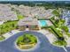 Aerial view showcasing clubhouse, manicured grounds, community pool, and neighborhood charm at 13241 Fountainbleau Dr, Clermont, FL 34711