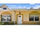 Close-up of front door with decorative glass, sidelight, and trimmed window with shutters at 13241 Fountainbleau Dr, Clermont, FL 34711
