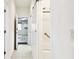 Hallway leading to a bathroom and garage with a modern sliding barn door at 13241 Fountainbleau Dr, Clermont, FL 34711
