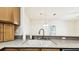 Bright kitchen with a stainless steel faucet and sink with a view to the living area at 13241 Fountainbleau Dr, Clermont, FL 34711
