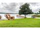 Scenic lake access with a wooden dock, gazebo, lush greenery, and picnic table, offering a serene waterfront experience at 13241 Fountainbleau Dr, Clermont, FL 34711