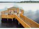 Picturesque lake gazebo featuring seating and a charming design, perfect for enjoying waterfront views and serene moments at 13241 Fountainbleau Dr, Clermont, FL 34711
