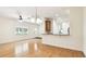 Spacious living room with hardwood floors and modern lighting fixtures at 13241 Fountainbleau Dr, Clermont, FL 34711