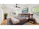 Comfortable bedroom with natural light, ceiling fan and a sliding barn door at 13241 Fountainbleau Dr, Clermont, FL 34711