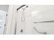 Modern shower with safety bars, hand shower and frameless sliding doors at 13241 Fountainbleau Dr, Clermont, FL 34711