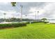 Community tennis courts surrounded by lush greenery, providing a private and well-maintained space for sports and recreation at 13241 Fountainbleau Dr, Clermont, FL 34711
