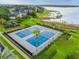 Community tennis courts and playground surrounded by lush landscaping with lake views in a desirable neighborhood at 13241 Fountainbleau Dr, Clermont, FL 34711