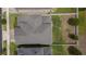 Aerial view of a home's roof with a fenced backyard with grass and trees at 3302 Stonegate Dr, Ocoee, FL 34761