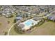 Aerial view highlighting a community pool, cabana, and lush landscaping within a well-planned neighborhood at 3302 Stonegate Dr, Ocoee, FL 34761