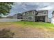 Grassy backyard featuring a fenced perimeter for privacy and security, with a view of the home's exterior at 3302 Stonegate Dr, Ocoee, FL 34761