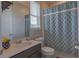 Bathroom with a white vanity, mirror, toilet, and a shower with a patterned blue curtain at 3302 Stonegate Dr, Ocoee, FL 34761
