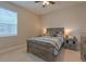 Cozy bedroom features a wooden bed frame with side tables and lamps, and a window at 3302 Stonegate Dr, Ocoee, FL 34761