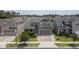 Exterior elevation showcasing a gray two-story home with a two-car garage and manicured landscaping at 3302 Stonegate Dr, Ocoee, FL 34761